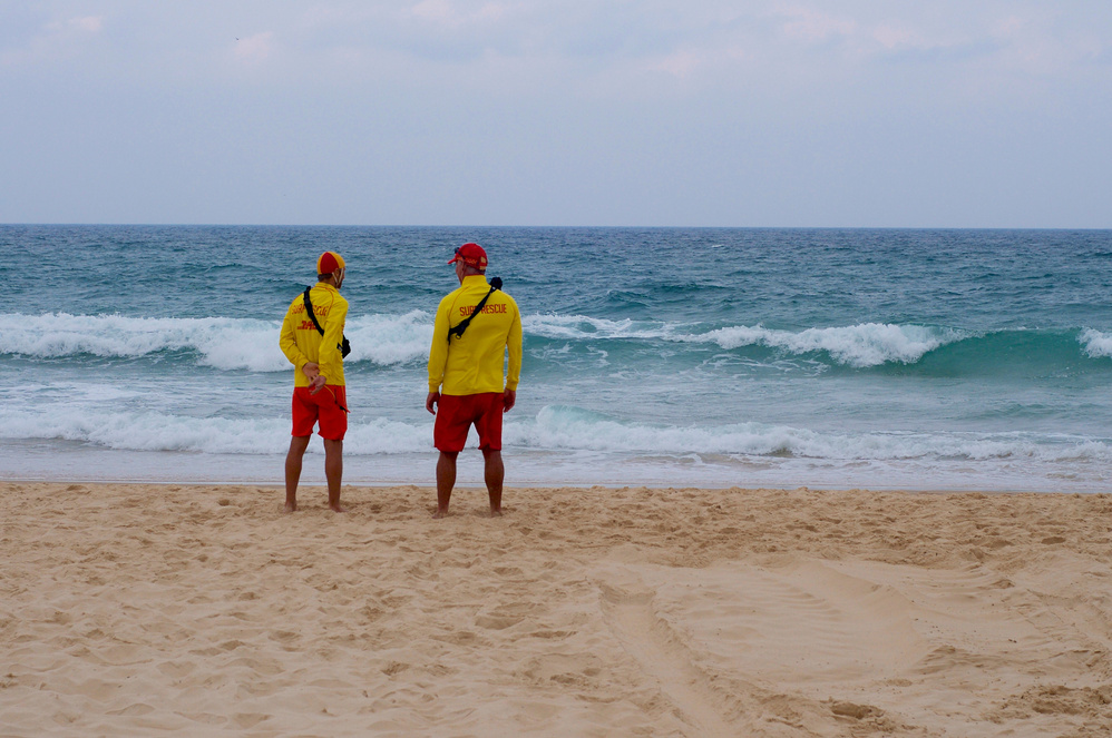 Two People Standing on the Beach